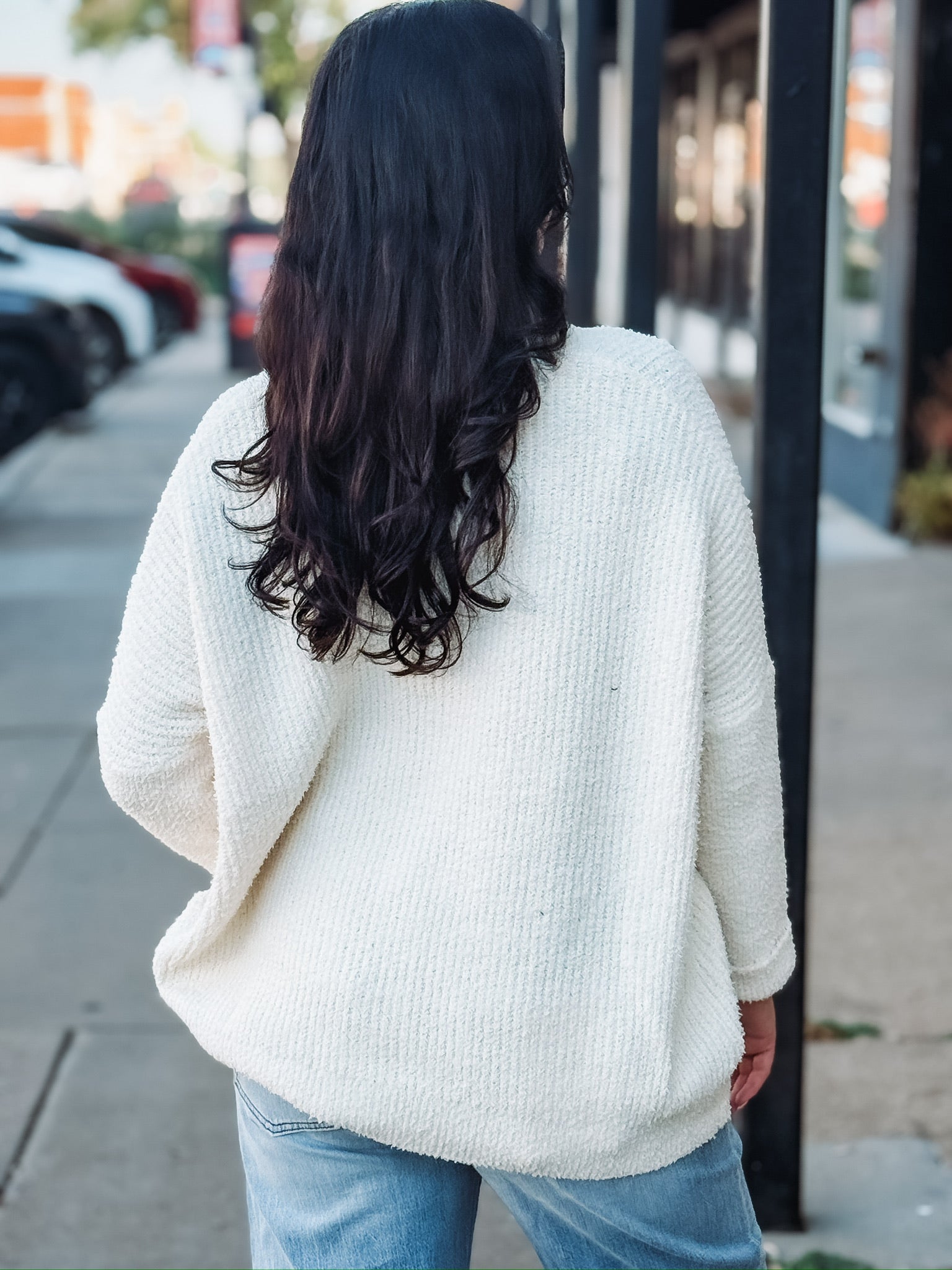 Cream long sleeve oversized cardigan with a v neck and tortoise buttons.