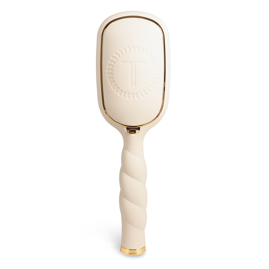 Beige paddle hairbrush with gold accents 