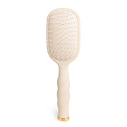 Beige paddle hairbrush with gold accents 