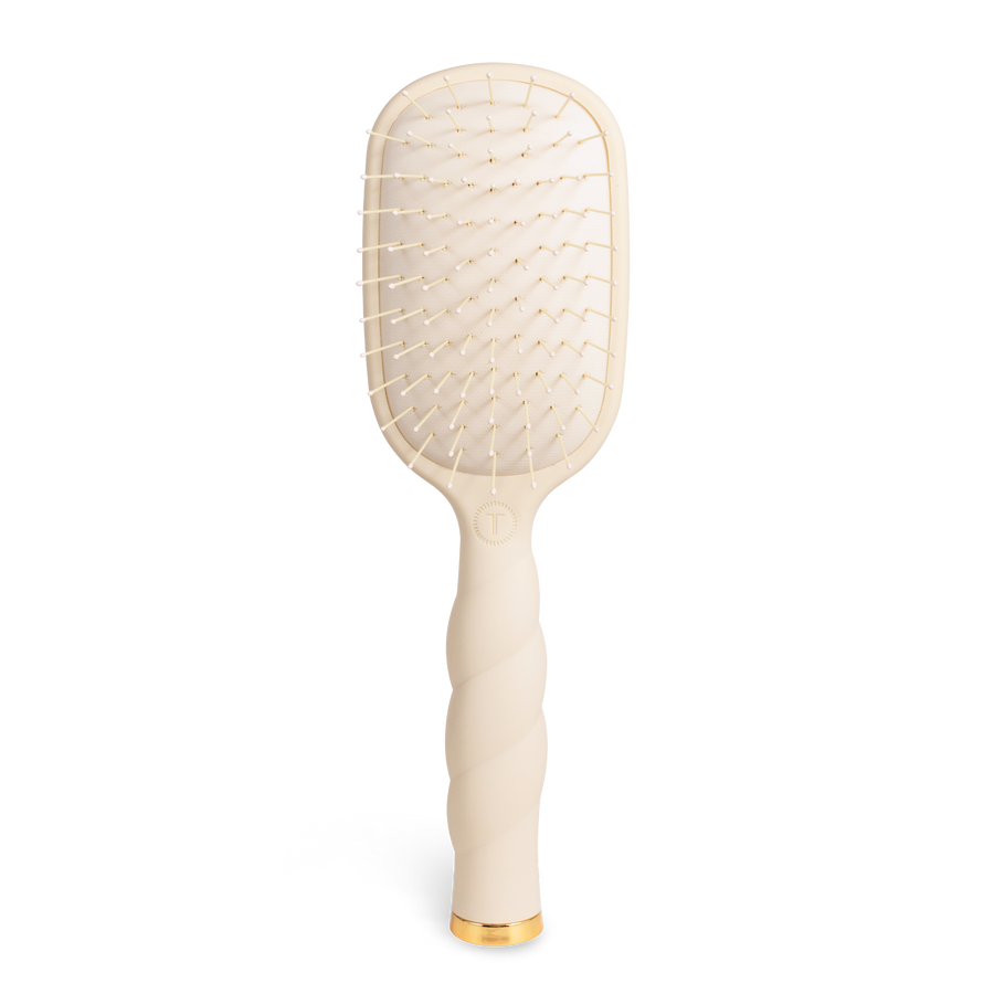 Beige paddle hairbrush with gold accents 