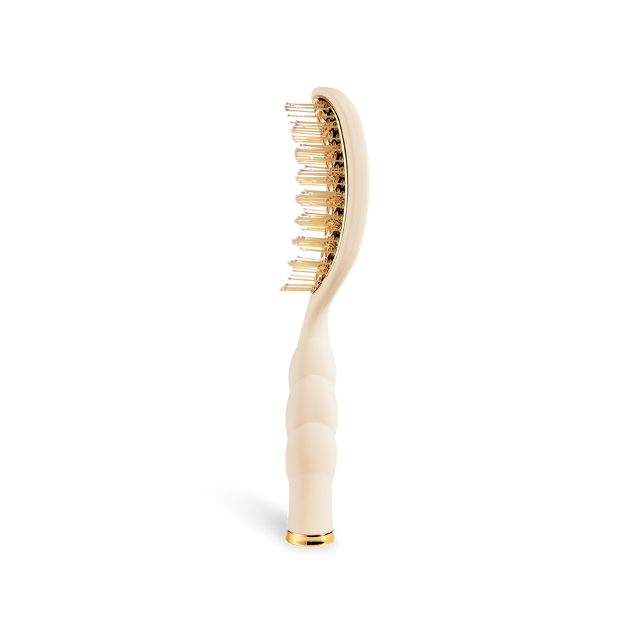 Hairbrush with gold bristles and tan handle