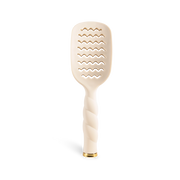 Beige paddle brush with wavy pattern on a white background