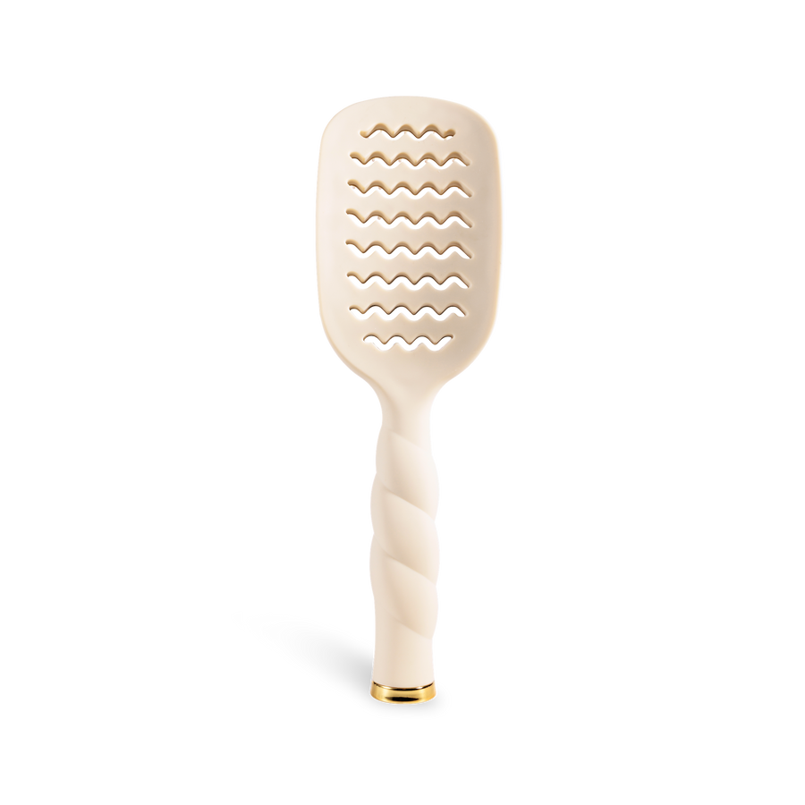 Beige paddle brush with wavy pattern on a white background