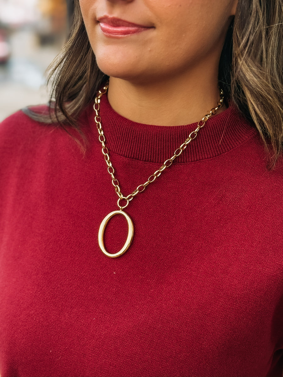 A bold oval pendant on a chunky gold chain