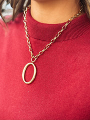 A bold oval pendant on a chunky gold chain