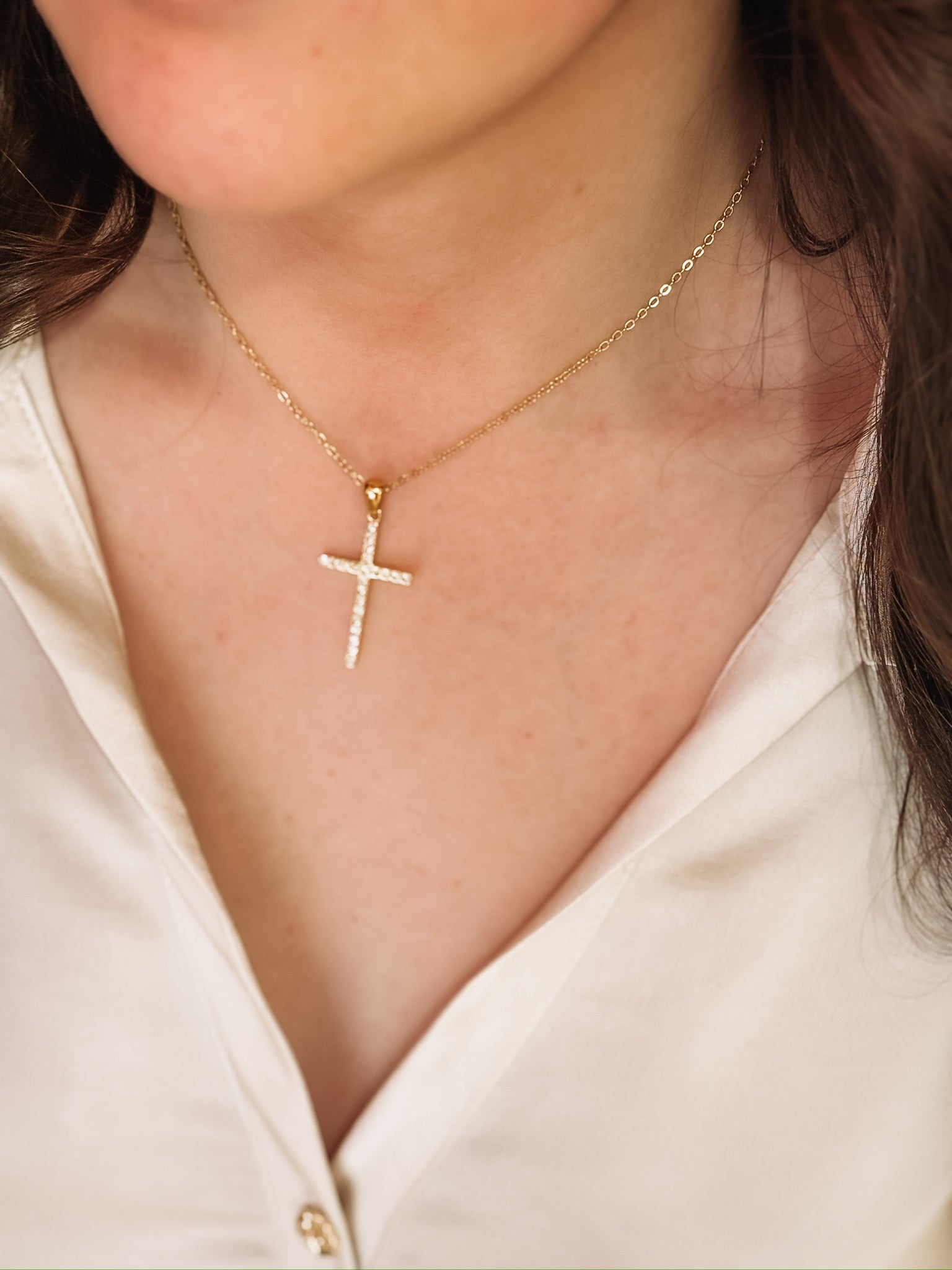 A short dainty chain with a CZ cross pendant.