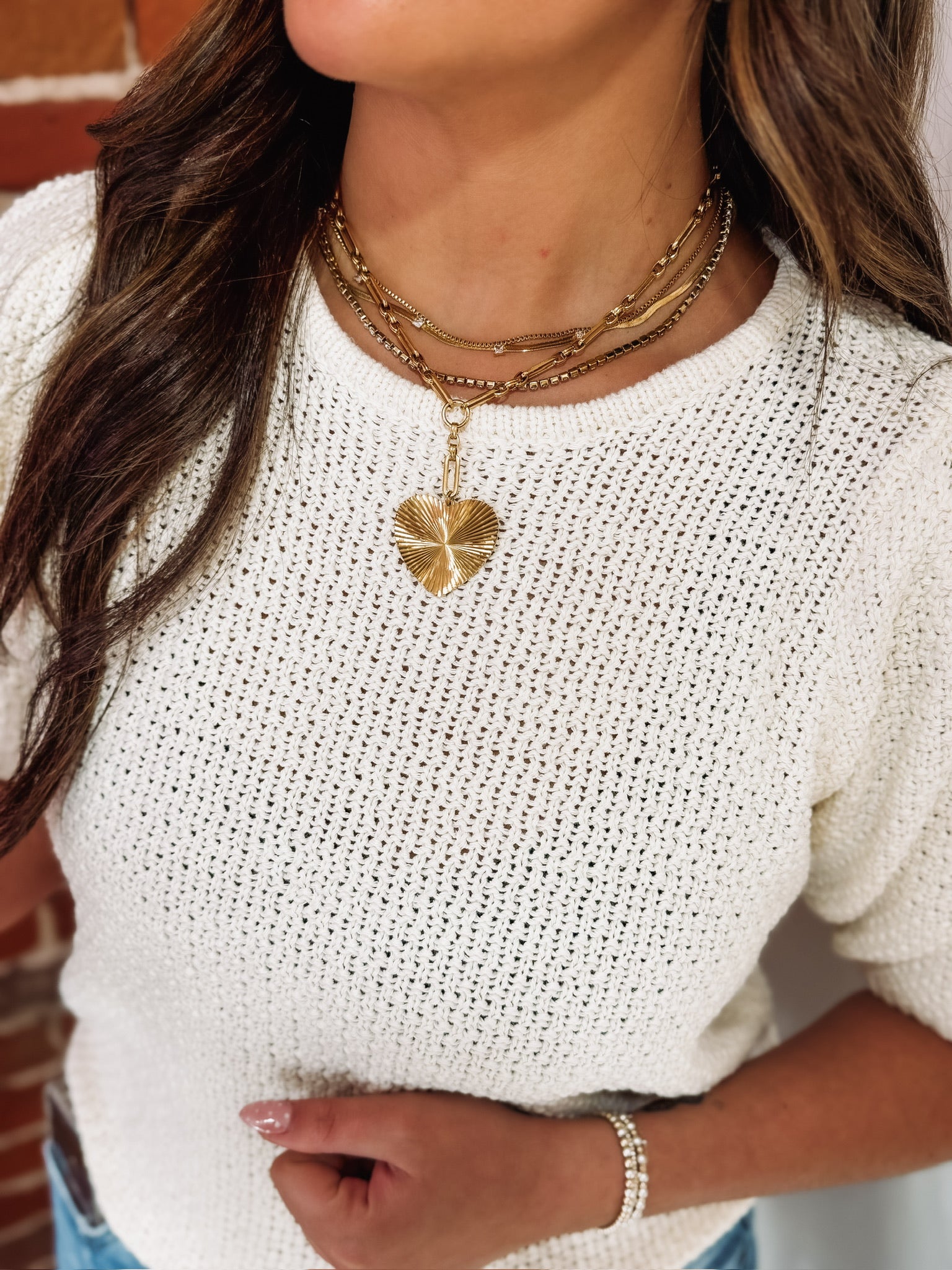 A short drop down pave heart pendant chain link necklace paired with  the Leah necklace.