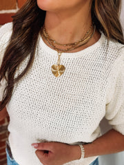 A short drop down pave heart pendant chain link necklace paired with  the Leah necklace.