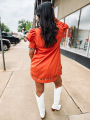 Orange above the knee length dress wit cheetah print trim.