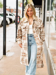 Muted neutral and rust long duster jacket with aztec print and a full button up front.