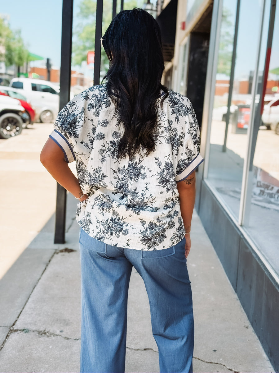 Blue V-neck floral blouse in a relaxed fit with short sleeves
