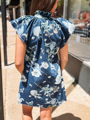 Denim button-up dress with a blue floral print, featuring short flutter sleeves and a flattering, slightly structured silhouette.