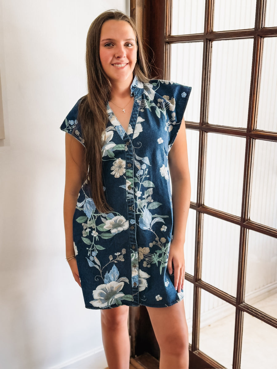 Denim button-up dress with a blue floral print, featuring short flutter sleeves and a flattering, slightly structured silhouette.