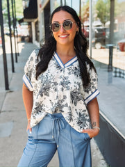 Blue V-neck floral blouse in a relaxed fit with short sleeves