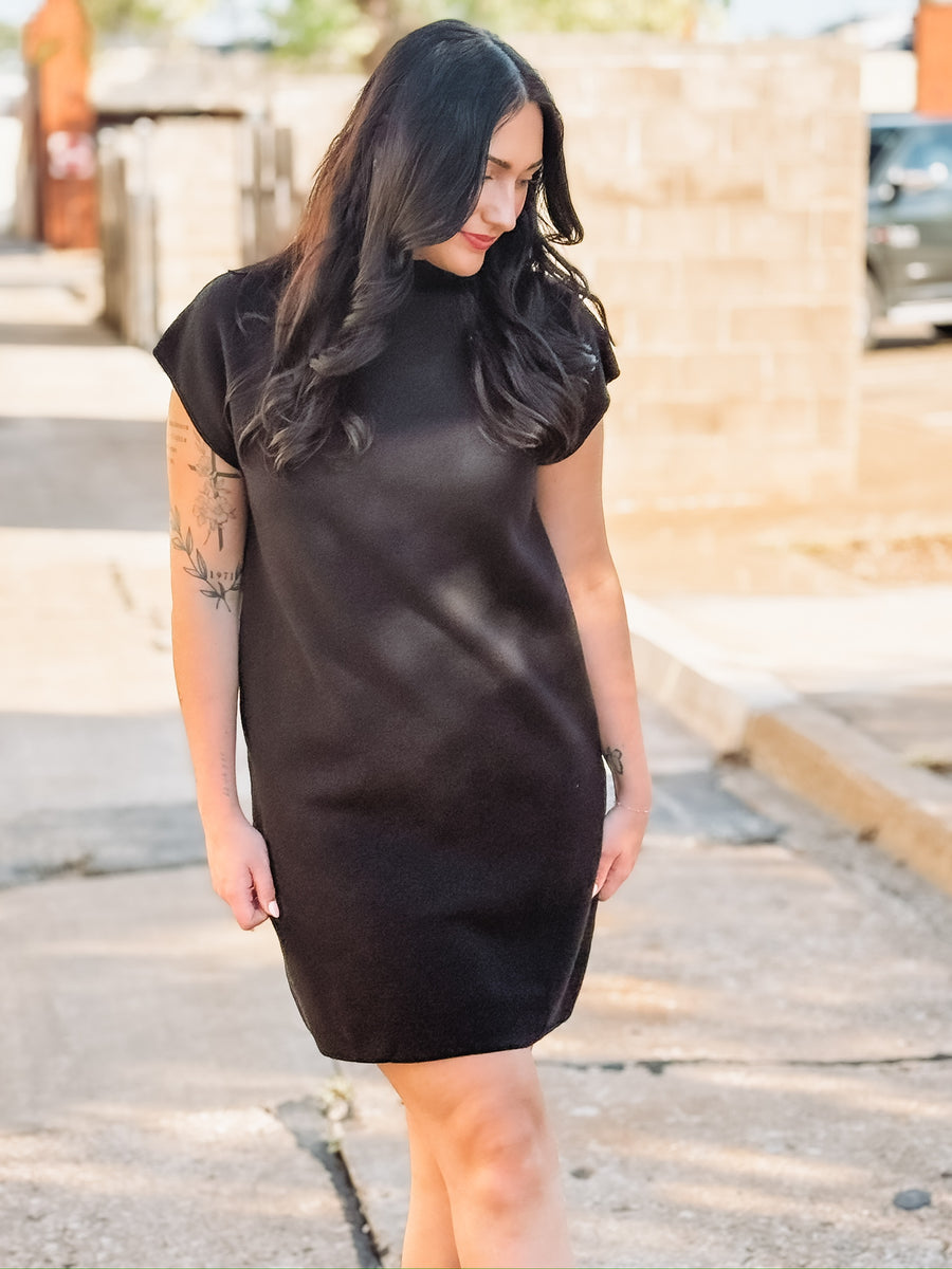 Black colored short sleeve mock neck mini  dress in a sweater material.