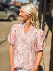 Blush pink short puff sleeve blouse with a champagne raised floral jacquard and china ruffle collar.