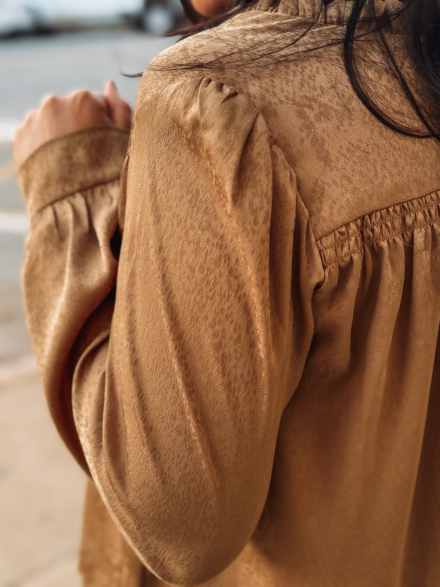 Bronze spotted long sleeve blouse with pleated detailing.