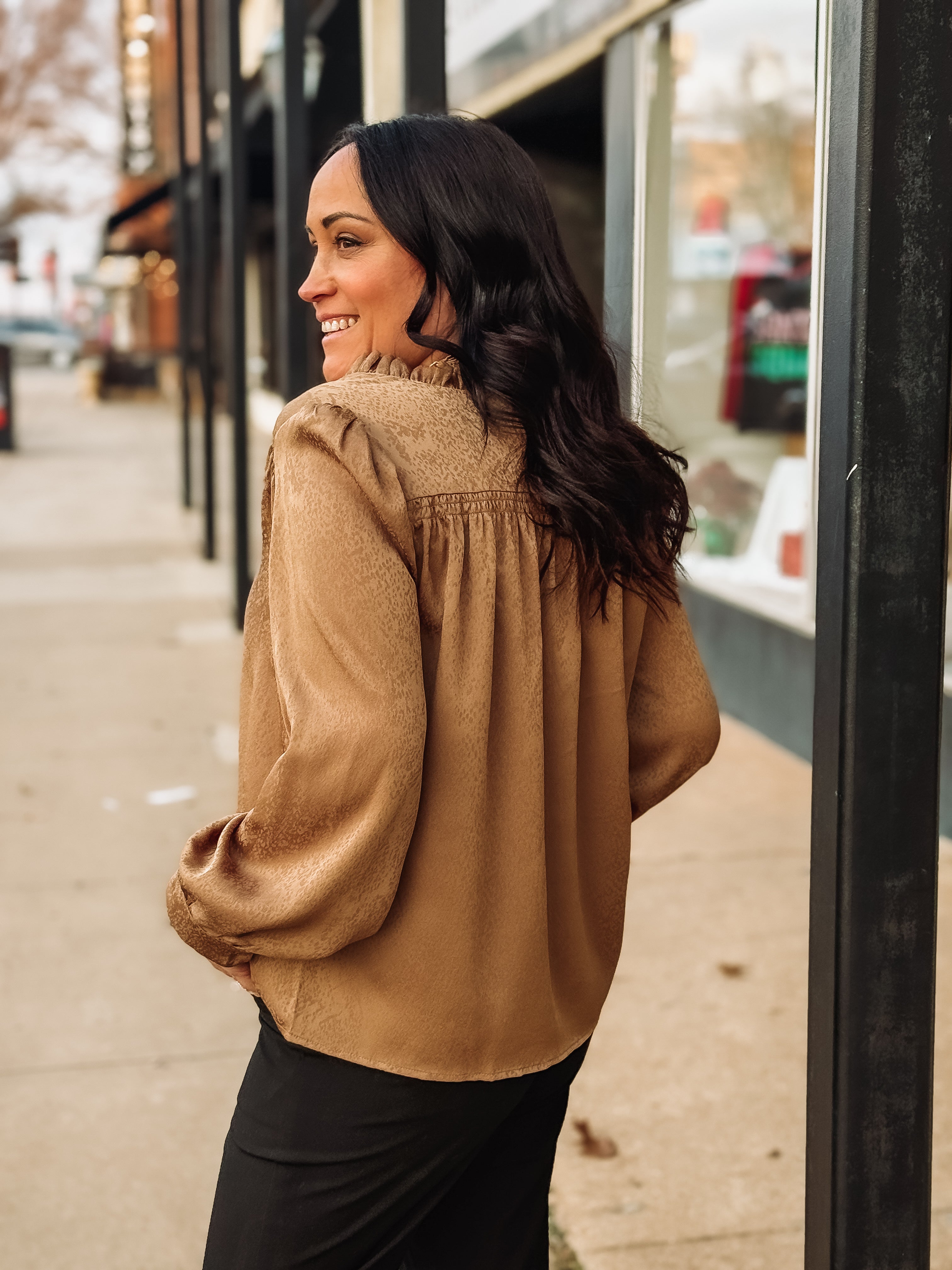 Bronze spotted long sleeve blouse with pleated detailing.