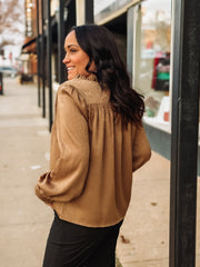 Bronze spotted long sleeve blouse with pleated detailing.