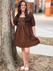 Brown dress with dainty black floral detail on a corduroy babydoll cut  short sleeve dress.