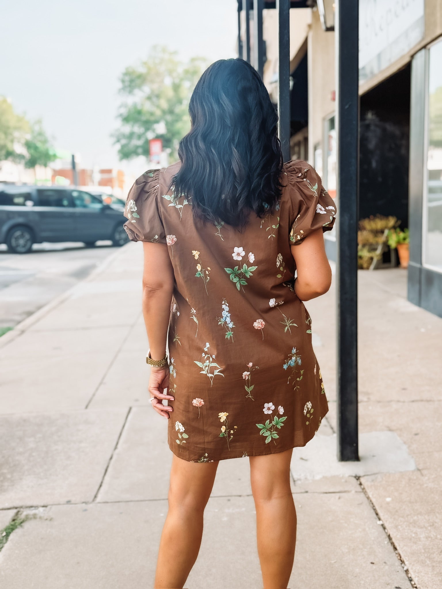 Brown floral button up mini dress dress with high ruffled neckline and puff short sleeves.