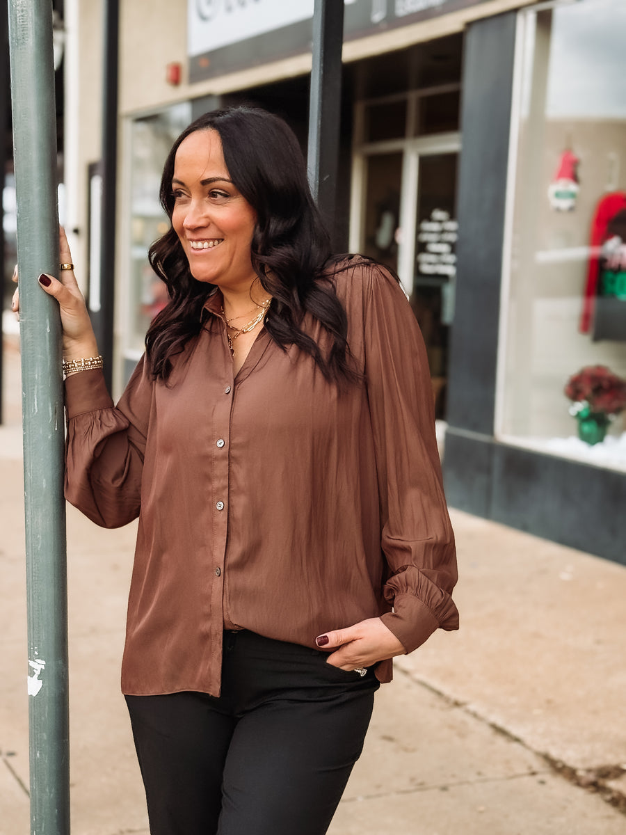 Brown long sleeve button up satin blouse with ruffle shoulders.