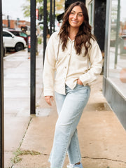 Cream long sleeve button up sherpa with detachable hood.