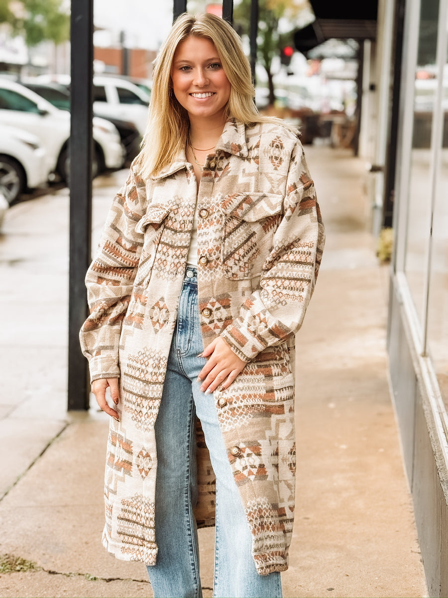 Muted neutral and rust long duster jacket with aztec print and a full button up front.
