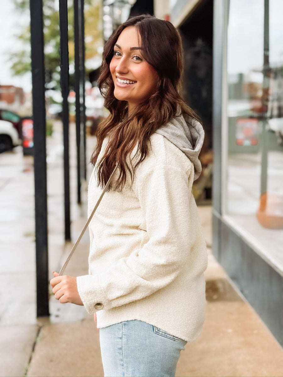 Cream long sleeve button up sherpa with detachable hood.
