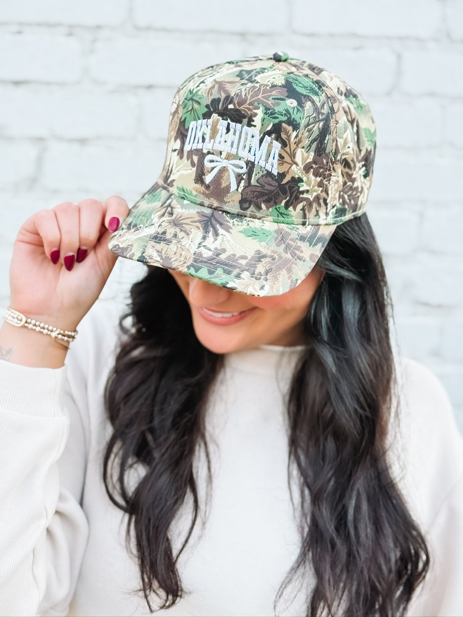 Camo Otto hat with printed OKLAHOMA and a bow.