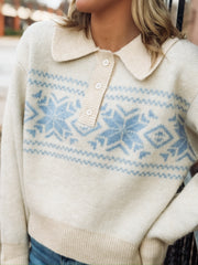 Collared cream long sleeve sweater with button detailing and a light blue fair isle design with snowflakes.