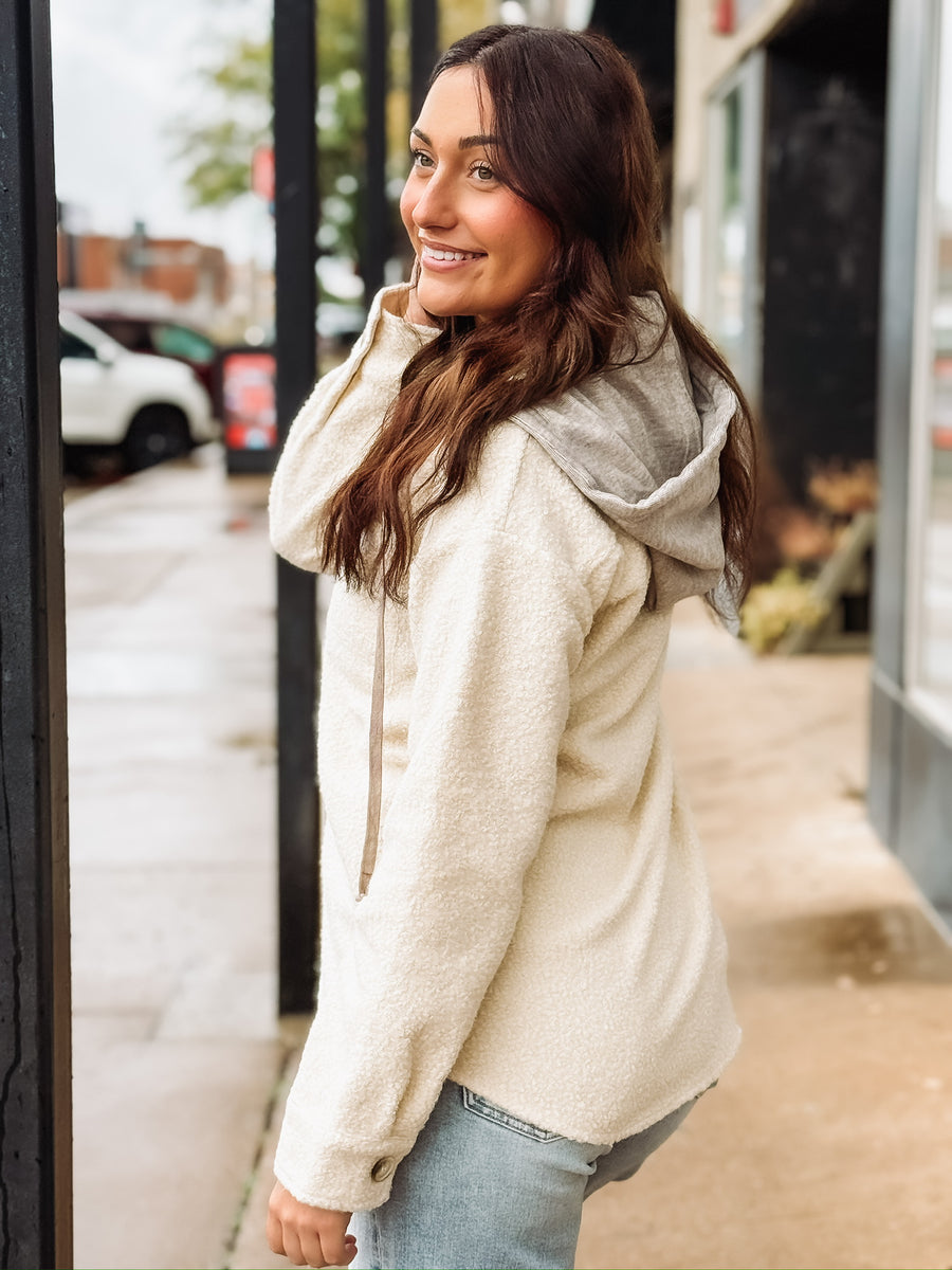 Cream long sleeve button up sherpa with detachable hood.