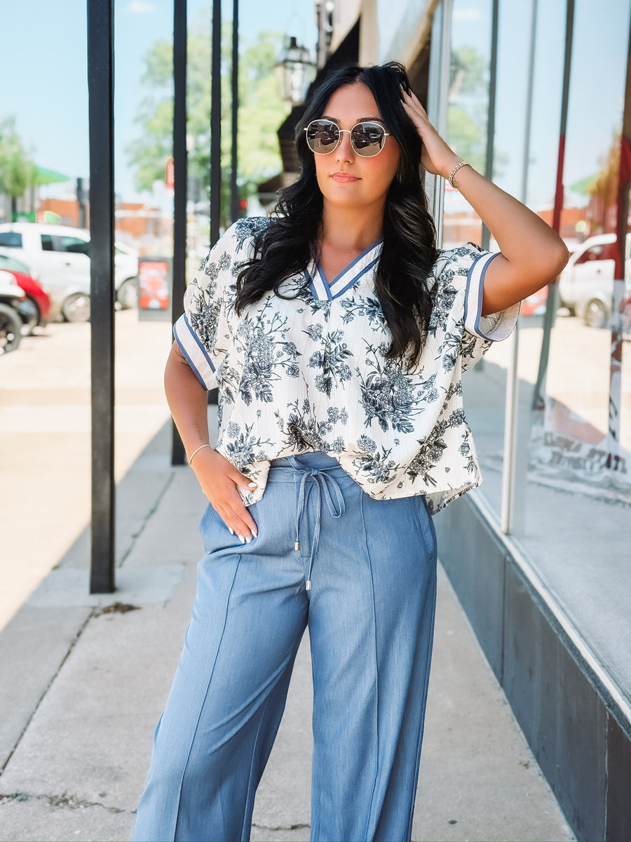 Light blue wide-leg pants with a drawstring waist, front seam detail, and relaxed fit