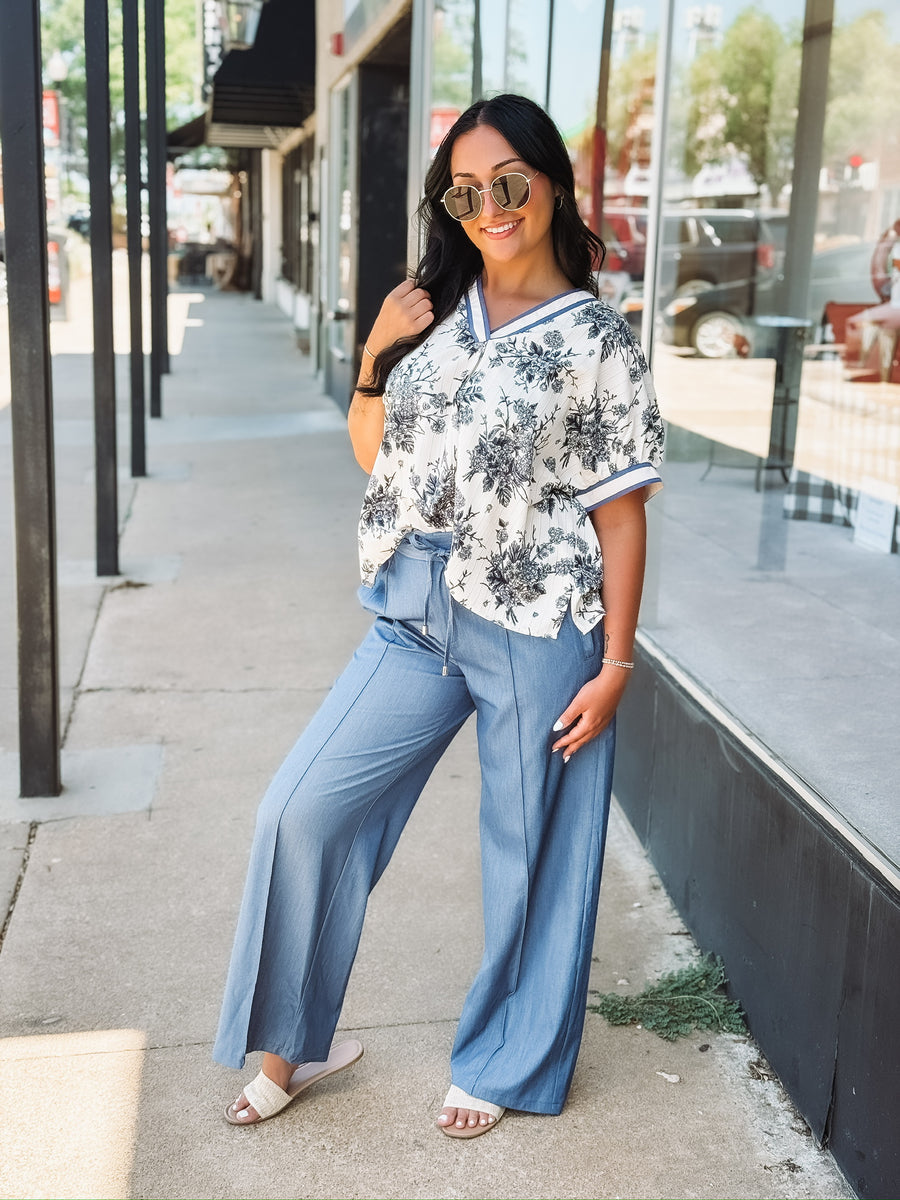 Light blue wide-leg pants with a drawstring waist, front seam detail, and relaxed fit