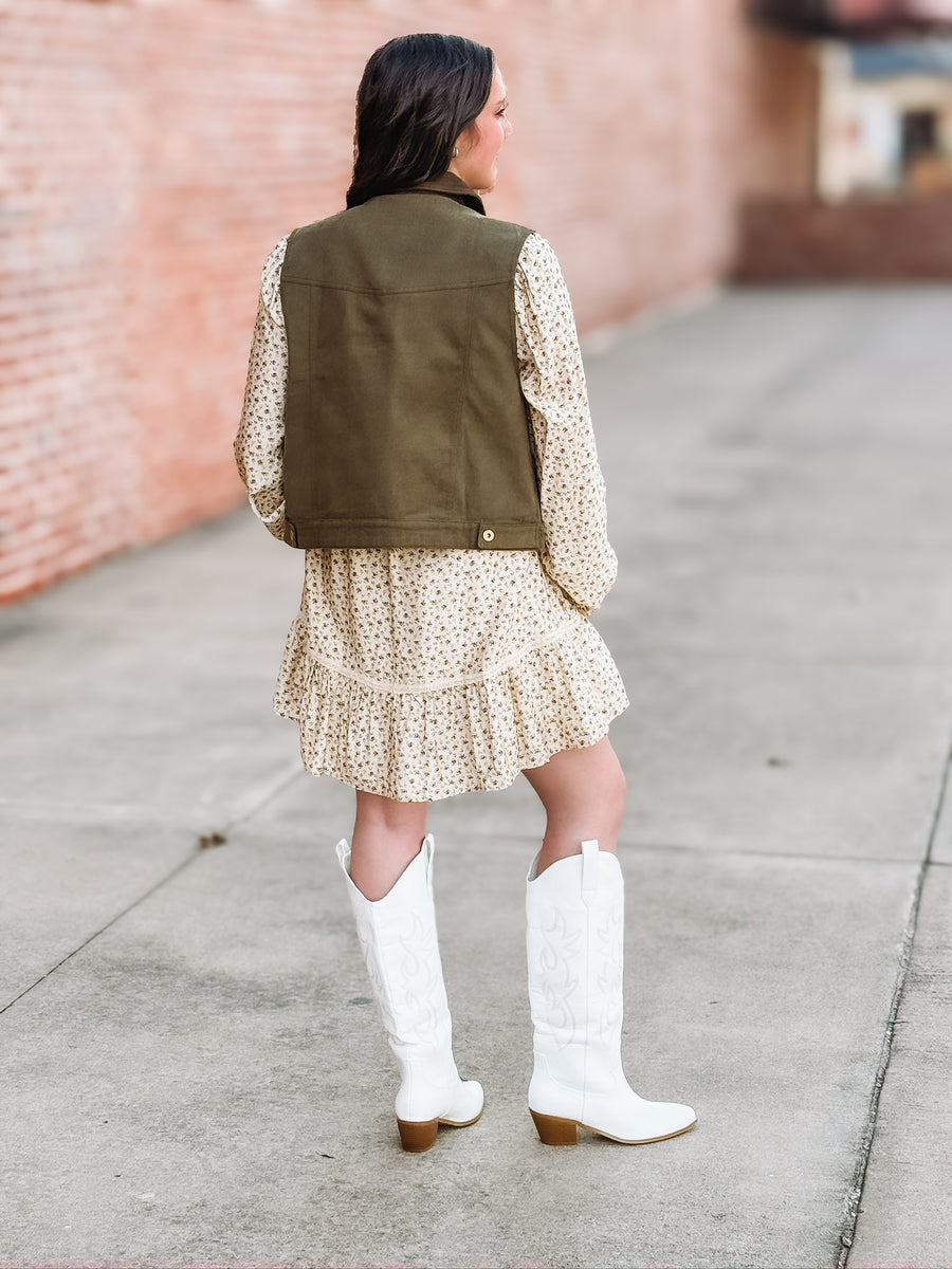 Olive utility vest with suede detailing and snap buttons.