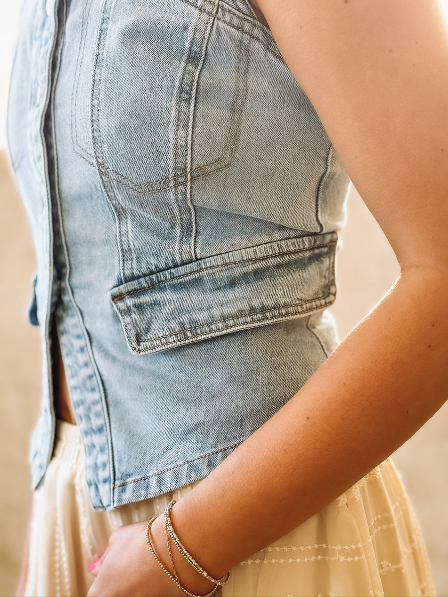 Fitted stretchy light wash denim vest top.
