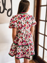 Green, Wine, Purple, Pink and Orange floral mini dress with puff sleeves and pink and green contrast seaming.