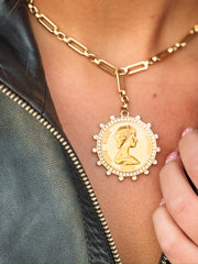 Gold necklace with large gold coin pendant with cz detailing.