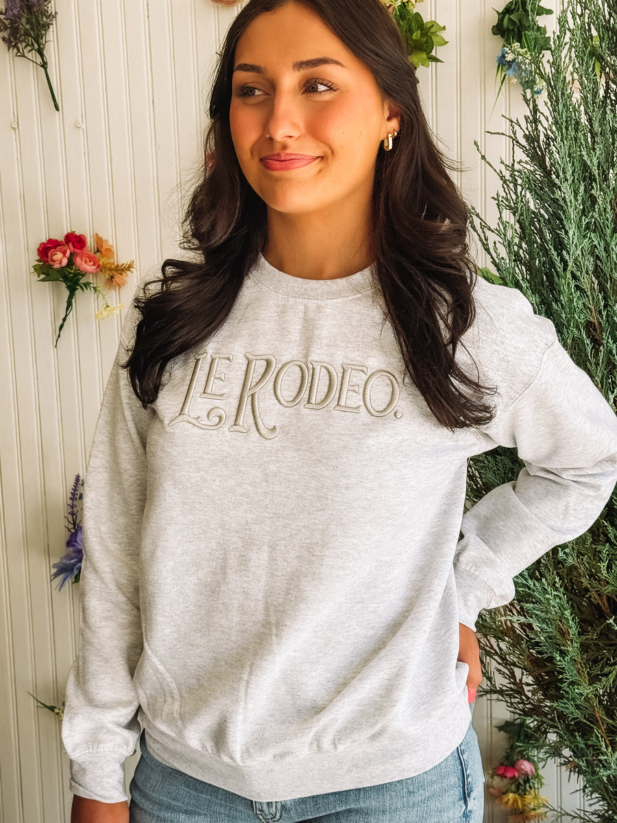 Washed gray crewneck sweatshirt with "Le Rodeo" typography