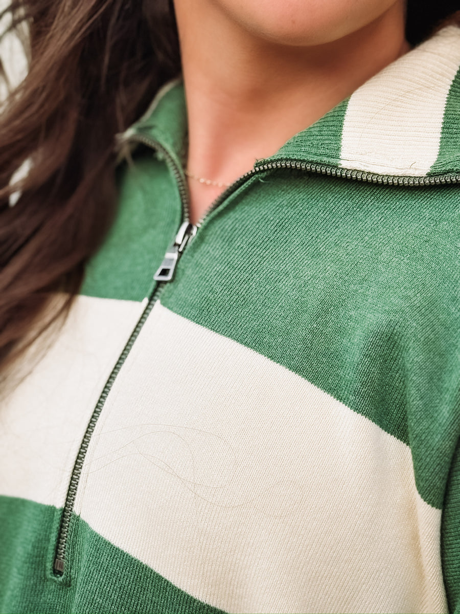 Green and cream striped quarter-zip pullover.