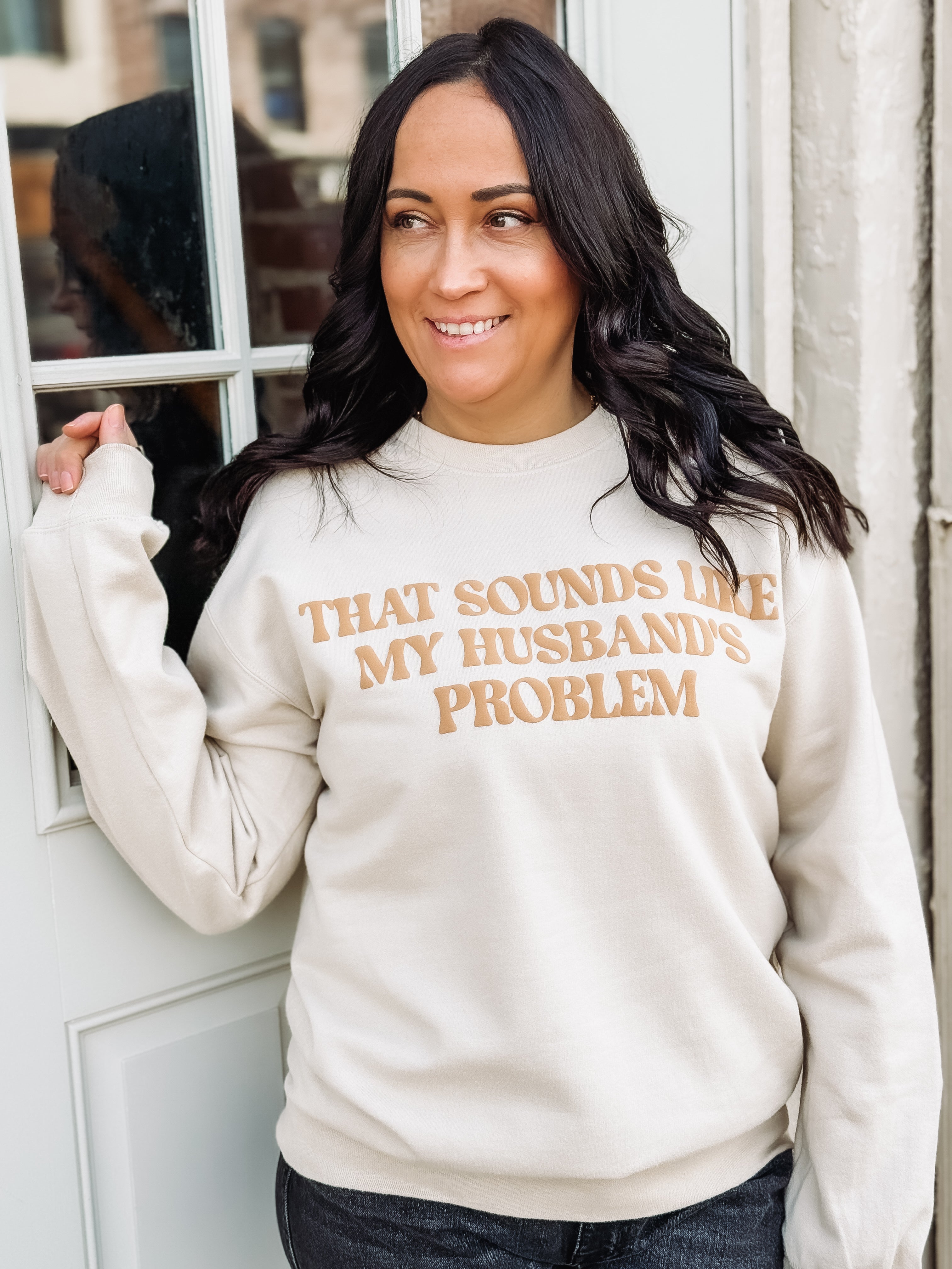 Cream colored sweatshirt with 'That sounds like my husbands problem' typography
