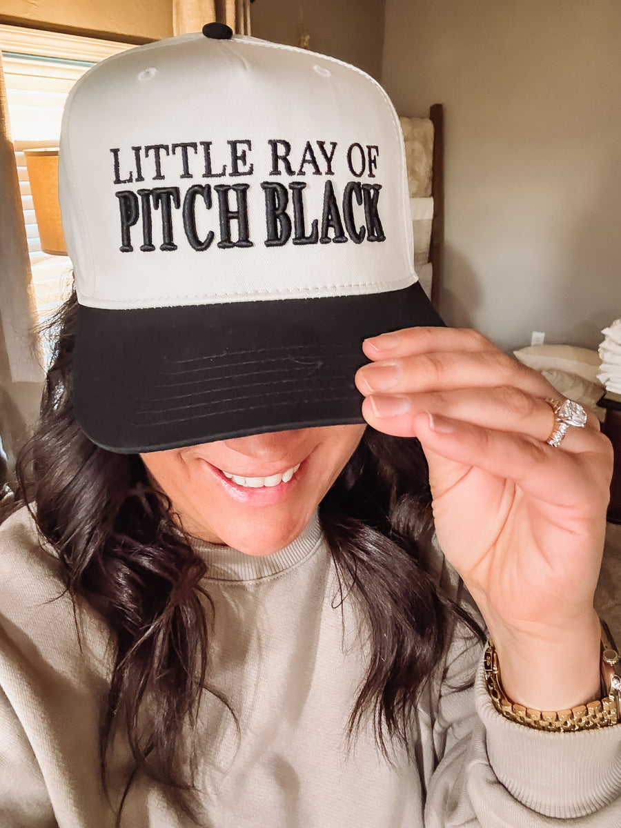 Black and cream canvas has with “Little Ray of Pitch Black” typography 