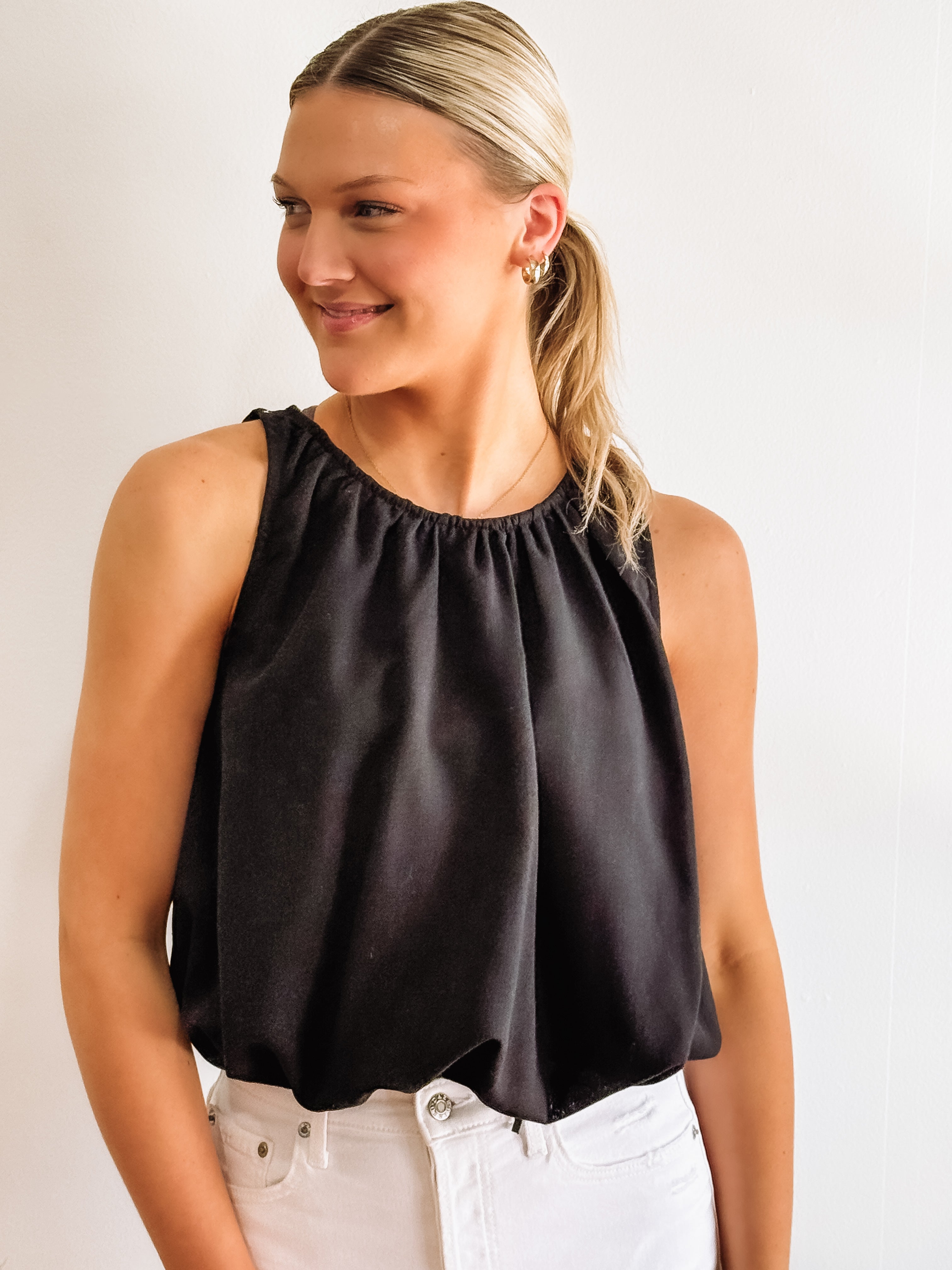 Black sleeveless bubble hemmed cropped tank.