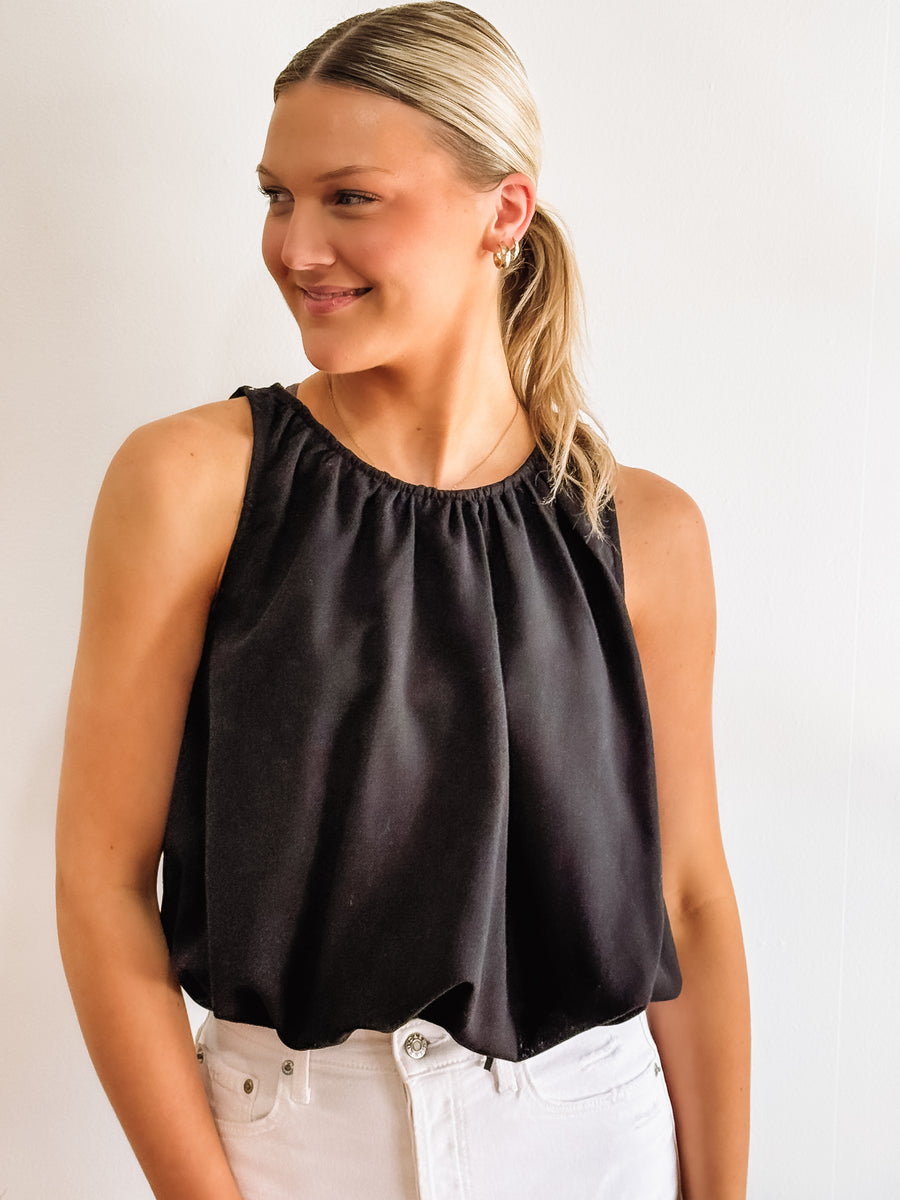 Black sleeveless bubble hemmed cropped tank.