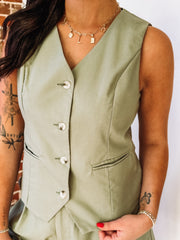 Sage green button up vest and short set.