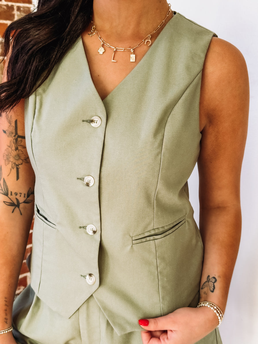 Sage green button up vest and short set.