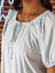 Blue and white striped short sleeve peasant blouse with self tie detail.