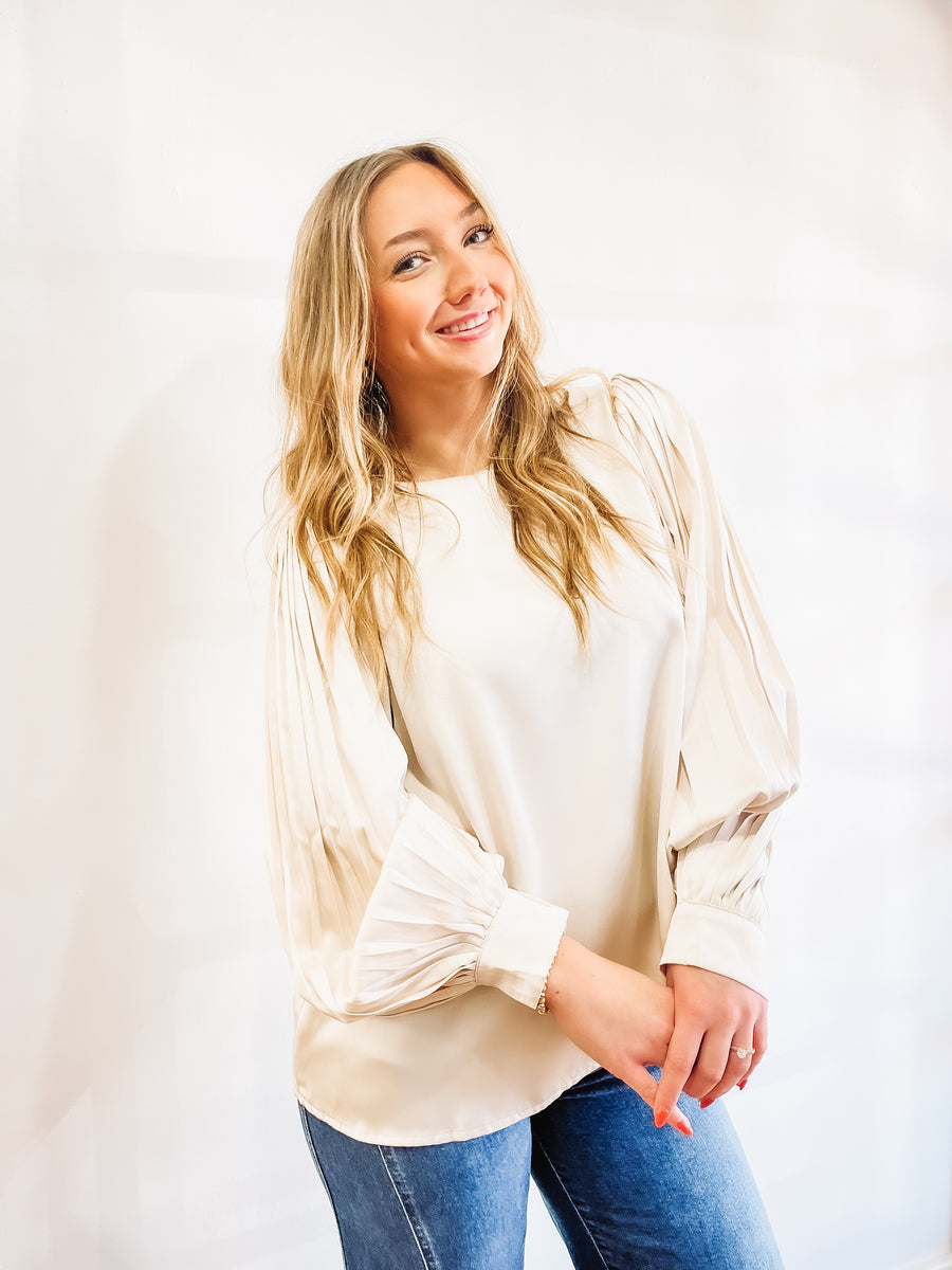 Champagne colored pleated long cuff sleeve blouse