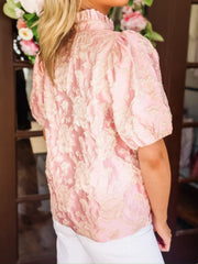 Blush pink short puff sleeve blouse with a champagne raised floral jacquard and china ruffle collar.