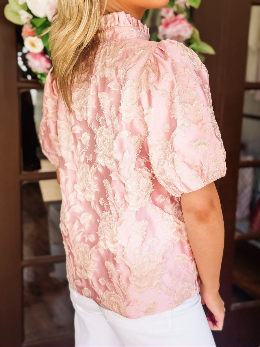 Blush pink short puff sleeve blouse with a champagne raised floral jacquard and china ruffle collar.